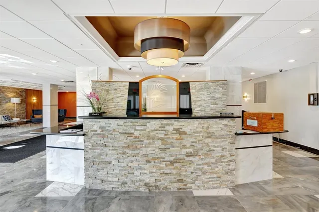 a large room with lots of potted plants and painted walls