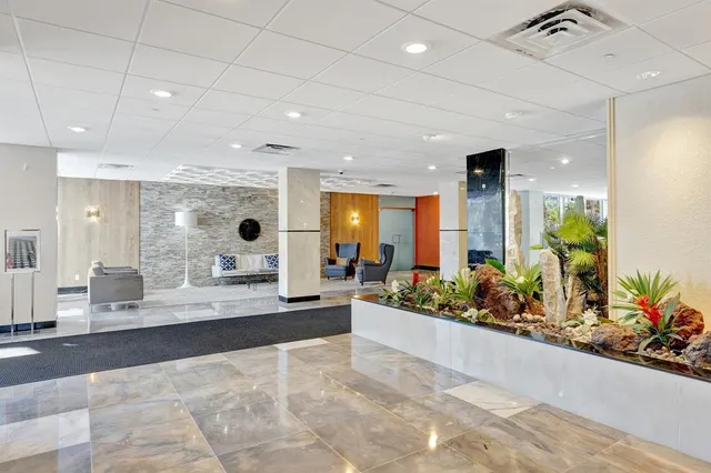 a living room with furniture and a dining table with kitchen view