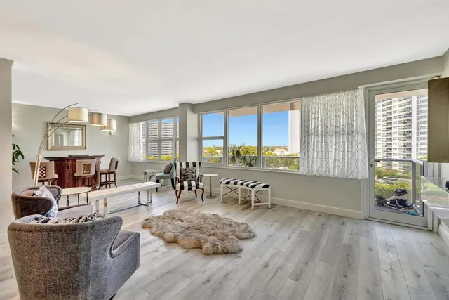 a living room with furniture and large windows