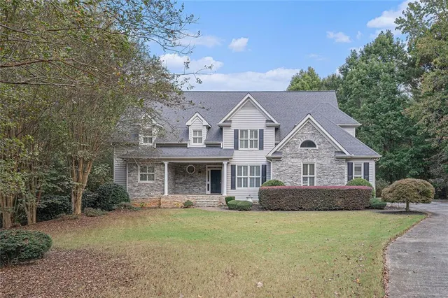 a front view of a house with garden