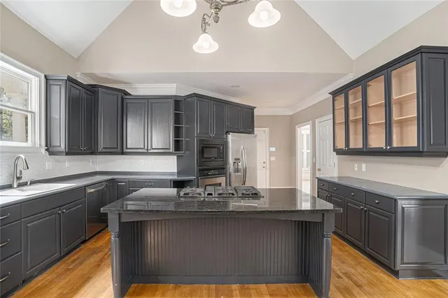 a kitchen with a sink cabinets and window