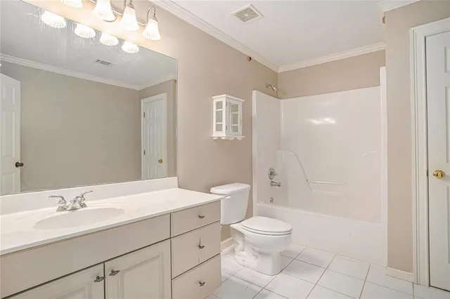 a bathroom with a toilet a sink a mirror a shower a vanity and window