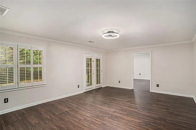 wooden floor in an empty room with a window