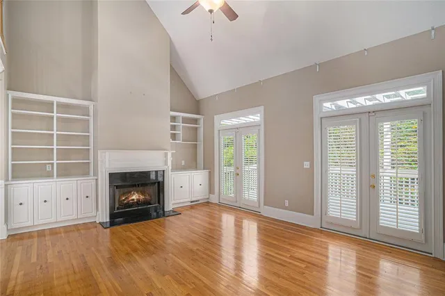 a view of empty room with a fireplace and wooden floor