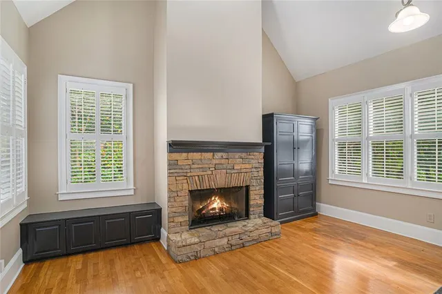 a living room with a fireplace next to a window
