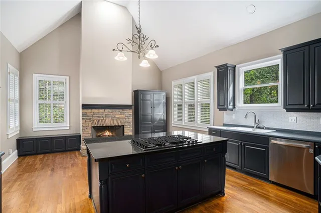 a kitchen with a sink and chandelier