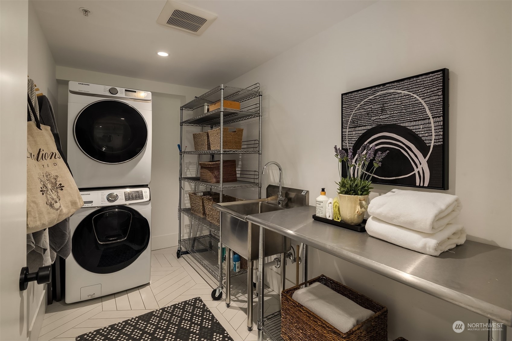 80 Vine Street, Unit 502 Seattle, WA 98121 - Photo 16 of 31 a living room with furniture and a washing machine