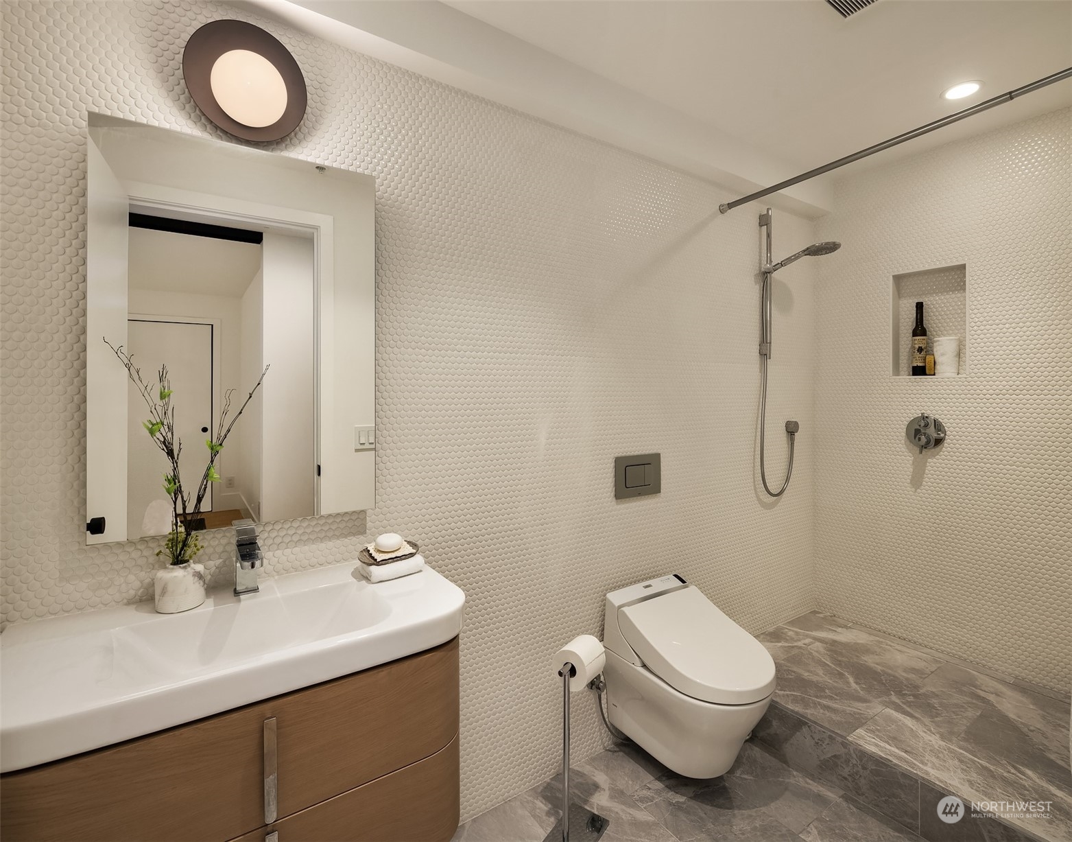 80 Vine Street, Unit 502 Seattle, WA 98121 - Photo 9 of 31 a bathroom with a toilet a sink and mirror