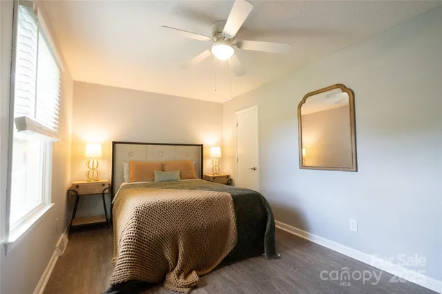 a bedroom with a bed and a painting on the wall