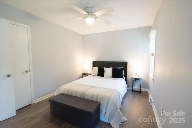 a bedroom with a bed and a ceiling fan
