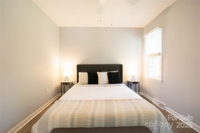 a bed sitting in a bedroom next to a window