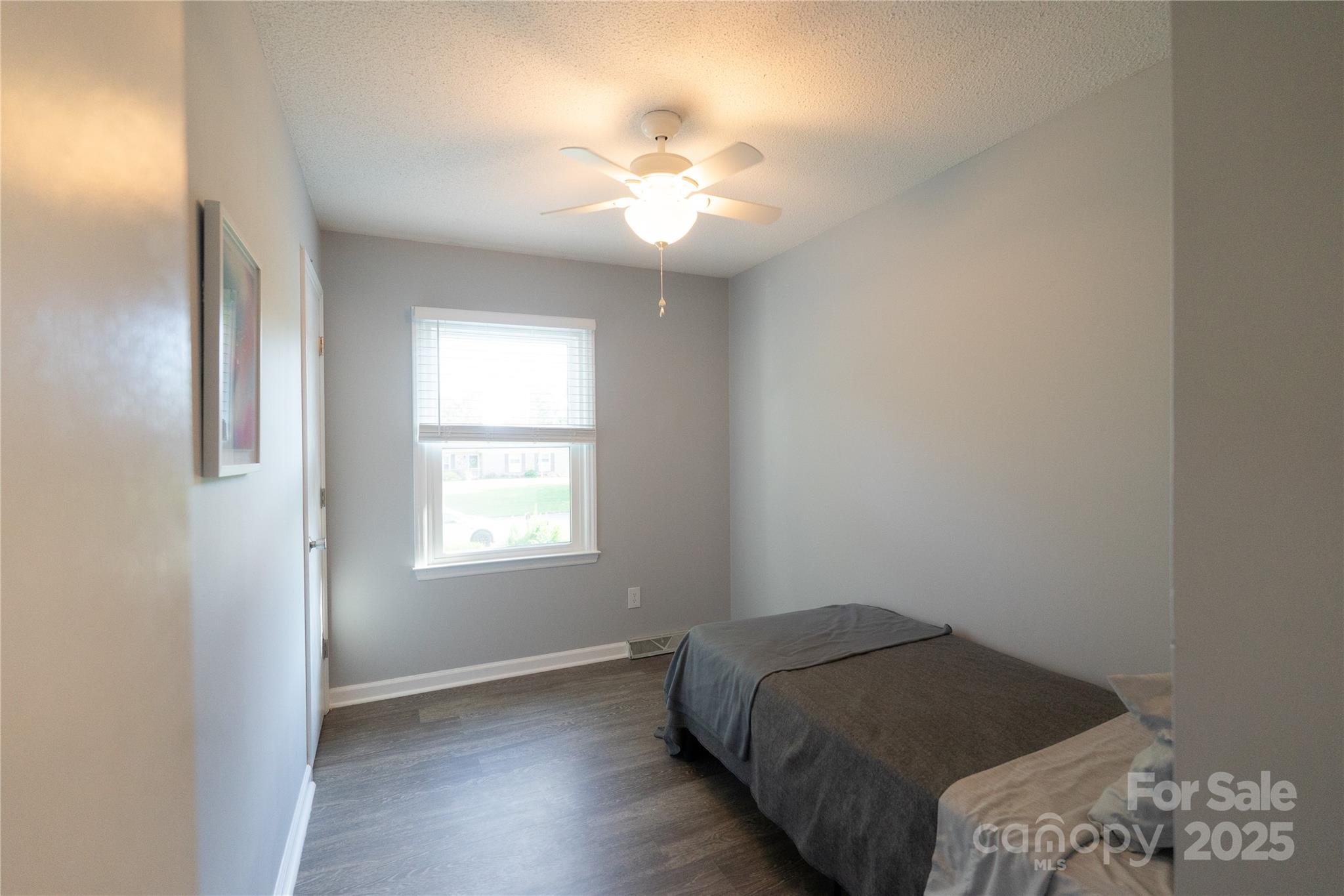 8012 Red Lantern Road Indian Trail, NC 28079 - Photo 22 of 33 a bedroom with a bed and a chandelier
