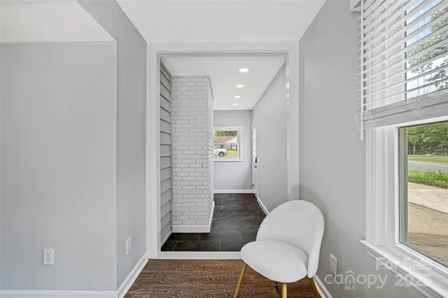 a bathroom with a sink a toilet a rug and a window