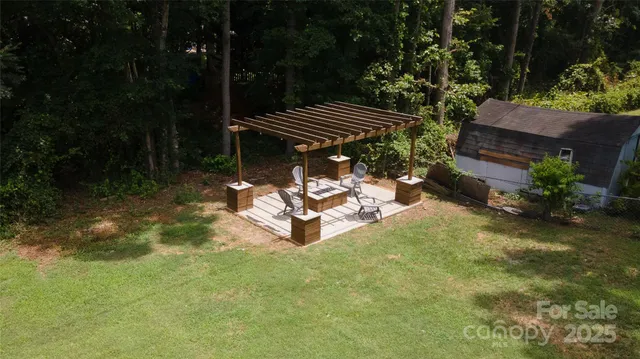 a view of a backyard with plants and a patio