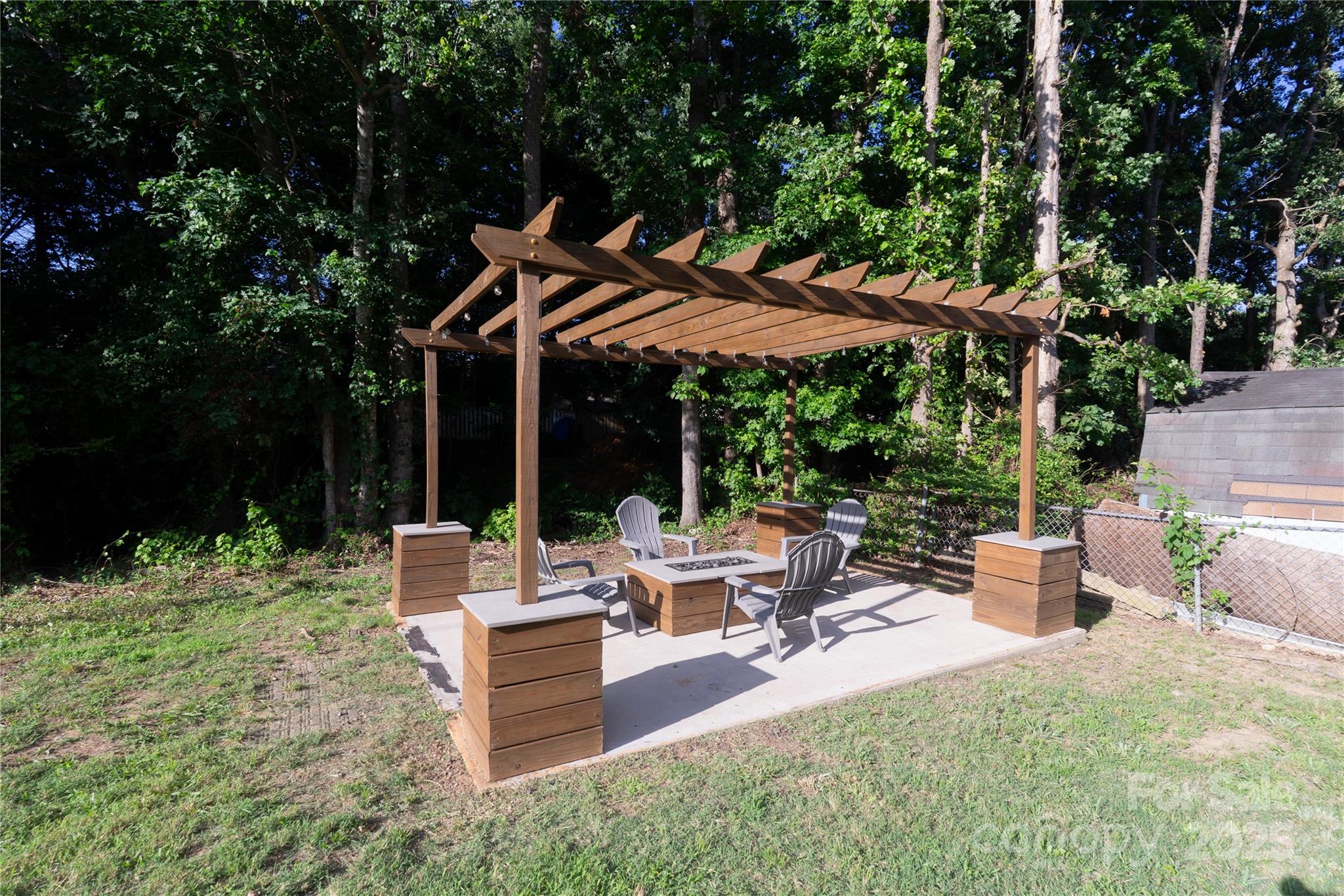 8012 Red Lantern Road Indian Trail, NC 28079 - Photo 30 of 33 a view of a patio with table and chairs potted plants and large tree