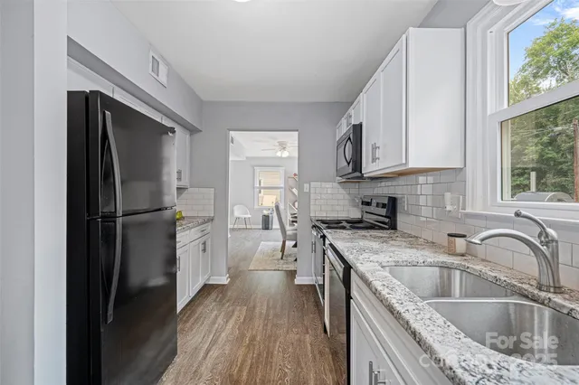 a kitchen with a sink stove and refrigerator