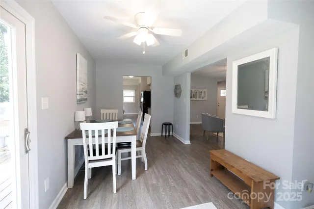a view of a dining room with furniture and wooden floor