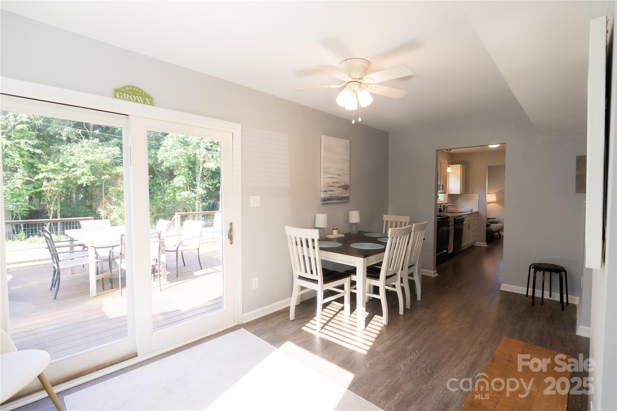 8012 Red Lantern Road Indian Trail, NC 28079 - Photo 7 of 33 a dining room with wooden floor a chandelier a glass table and chairs