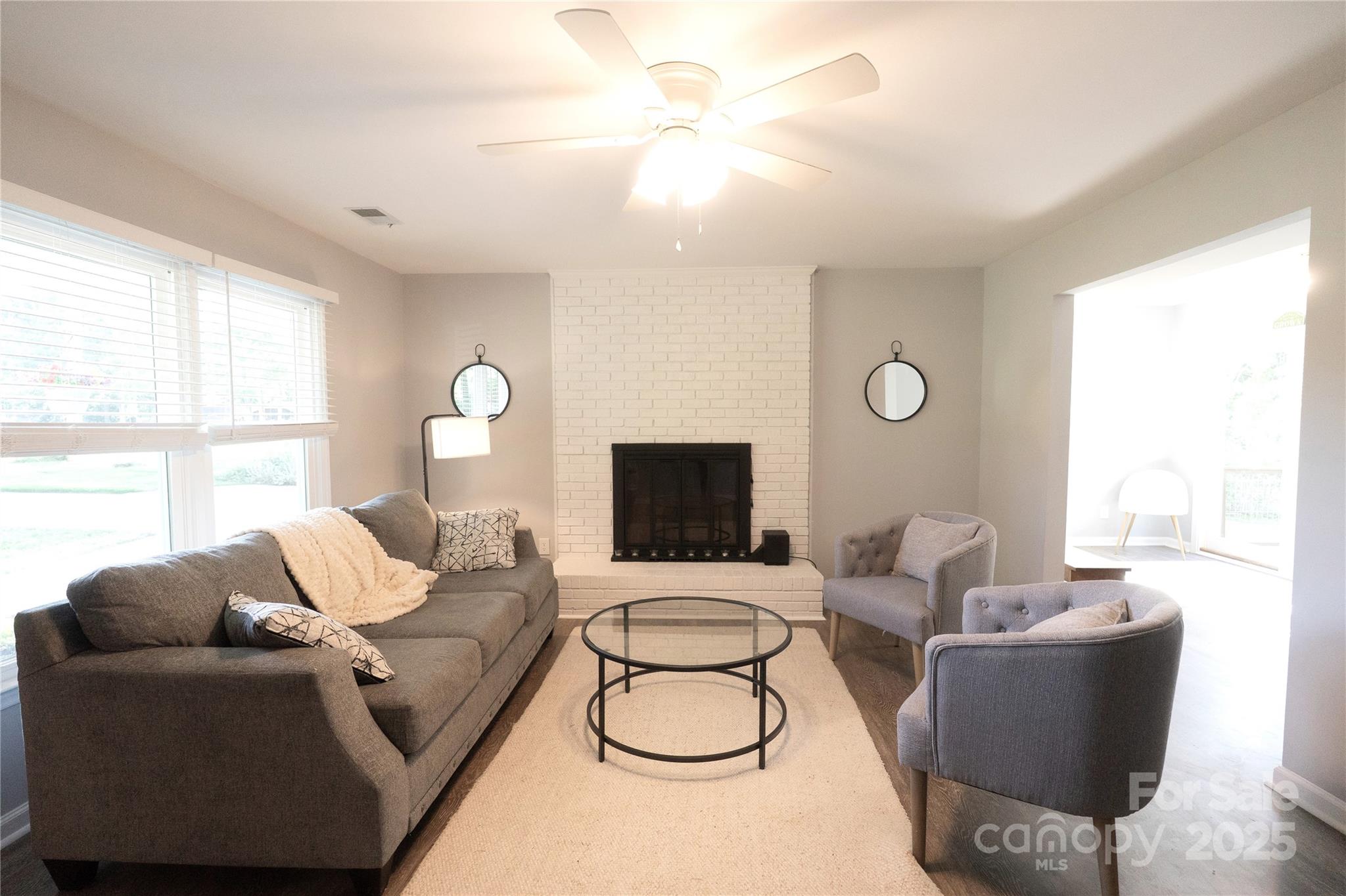 8012 Red Lantern Road Indian Trail, NC 28079 - Photo 8 of 33 a living room with furniture a large window and a chandelier
