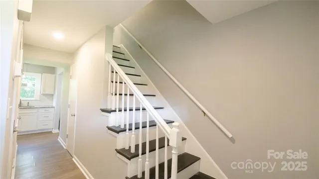 a view of entryway and hall with wooden floor