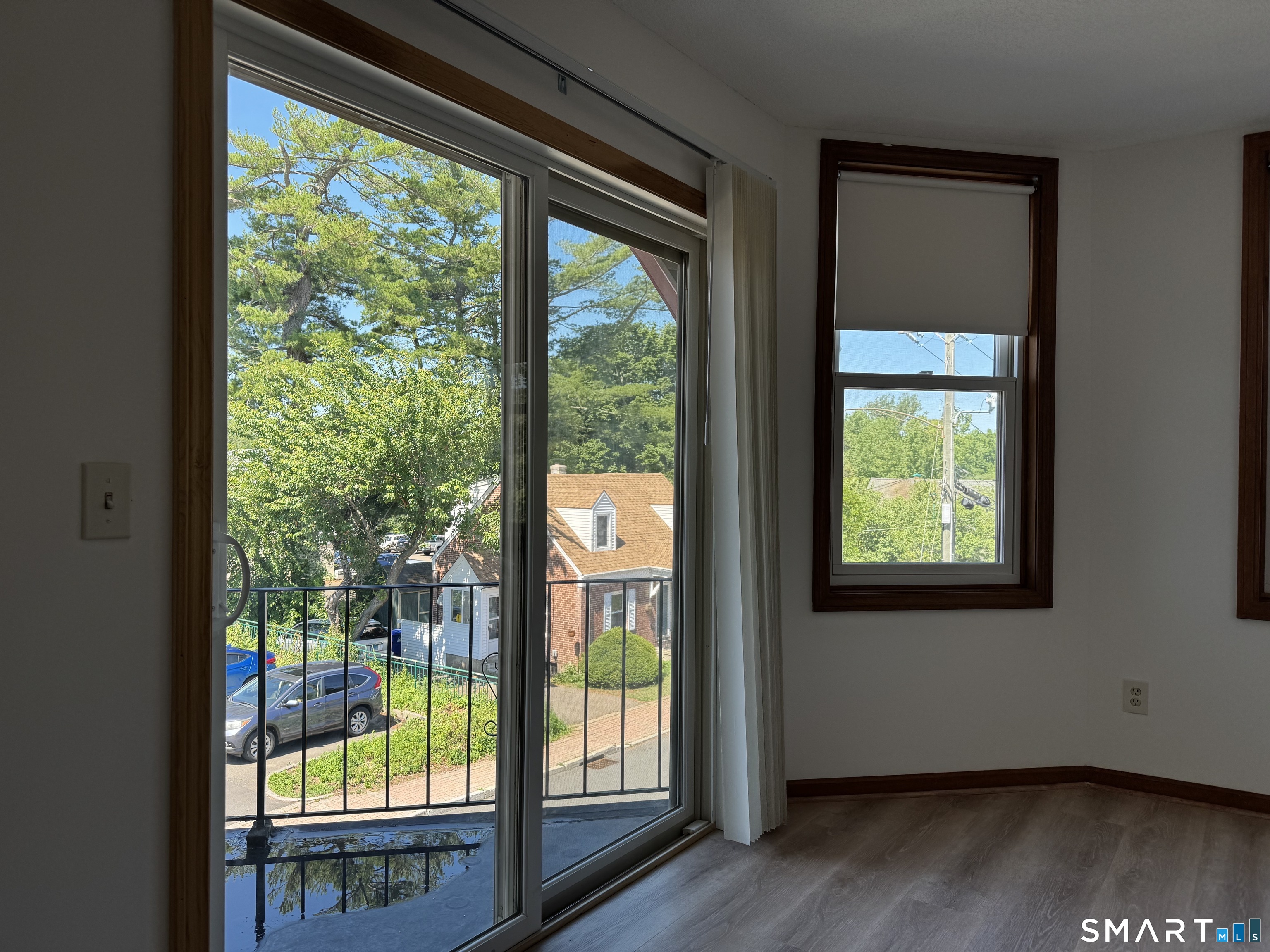 1022 Main Street, Unit 7 Branford, CT 06405 - Photo 9 of 10 a view of an empty room with wooden floor and a window