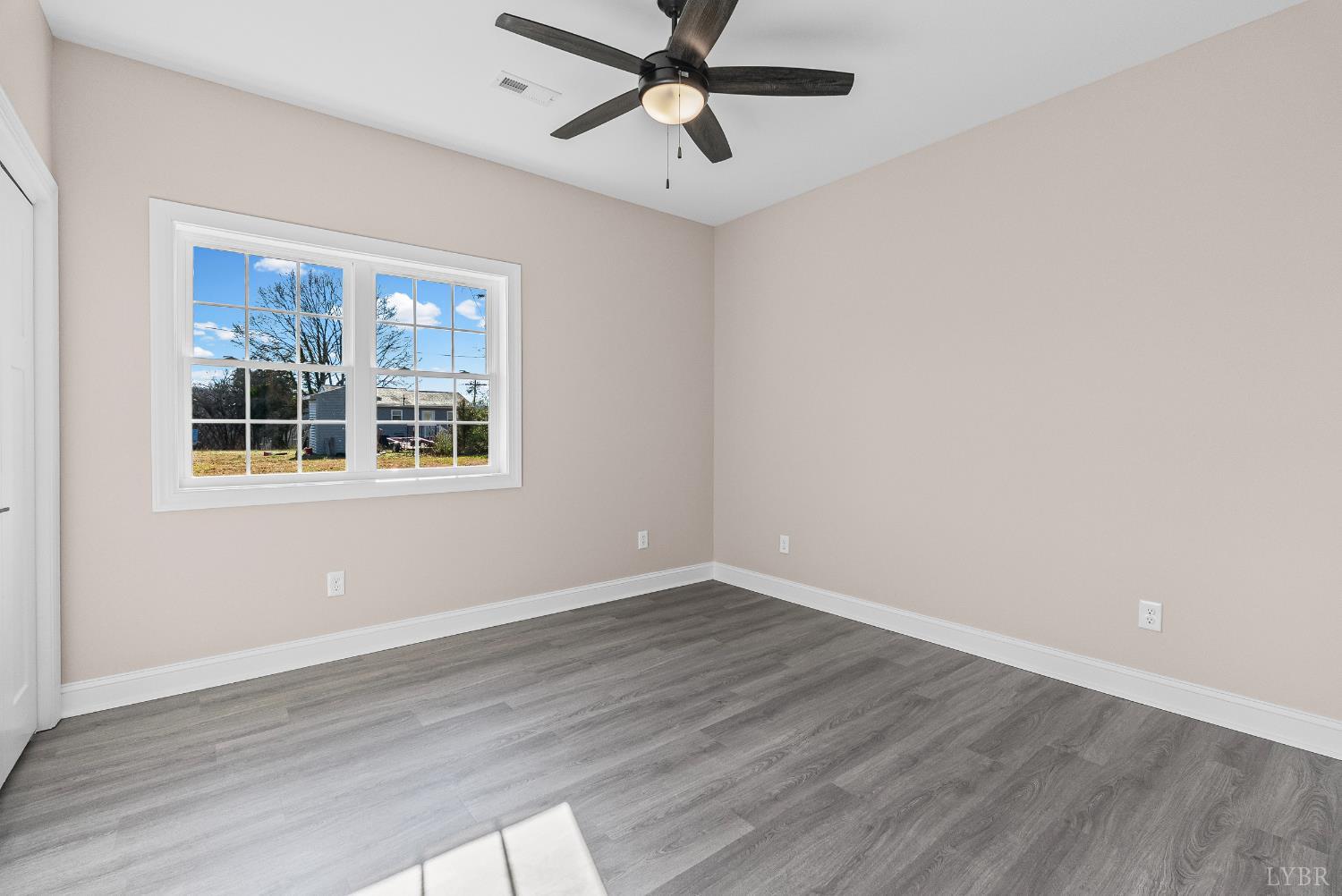1303 4th Street Altavista, VA 24517 - Photo 18 of 36 a view of empty room with wooden floor and fan