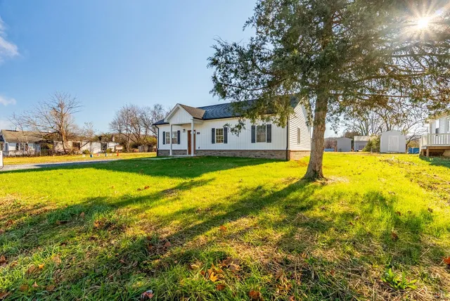 a view of a house with swimming pool and yard