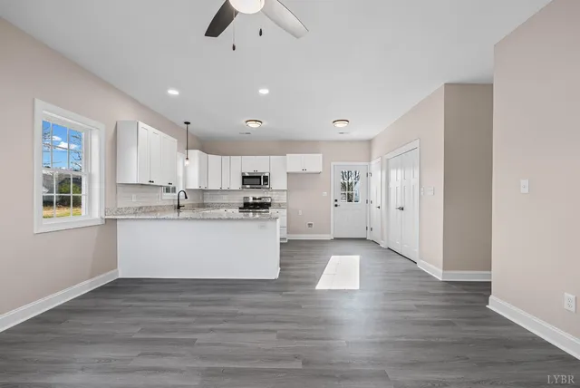 a view of kitchen with wooden floors and refrigerator