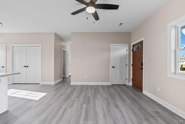 wooden floor in an empty room with a window