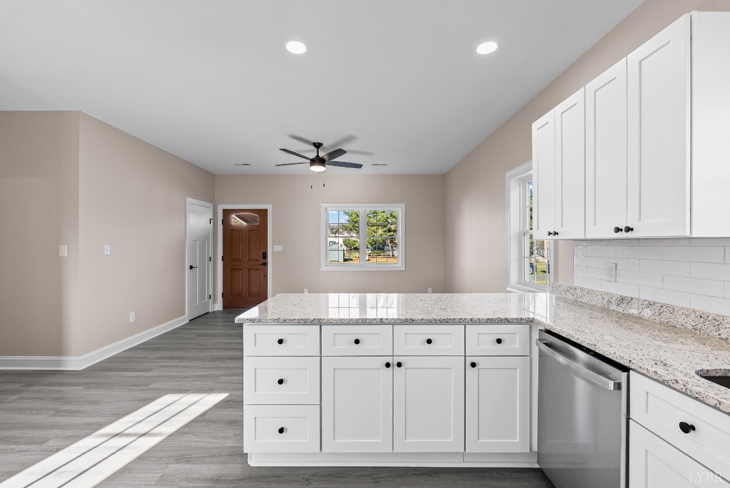 1303 4th Street Altavista, VA 24517 - Photo 9 of 36 a kitchen with granite countertop a white cabinets and window