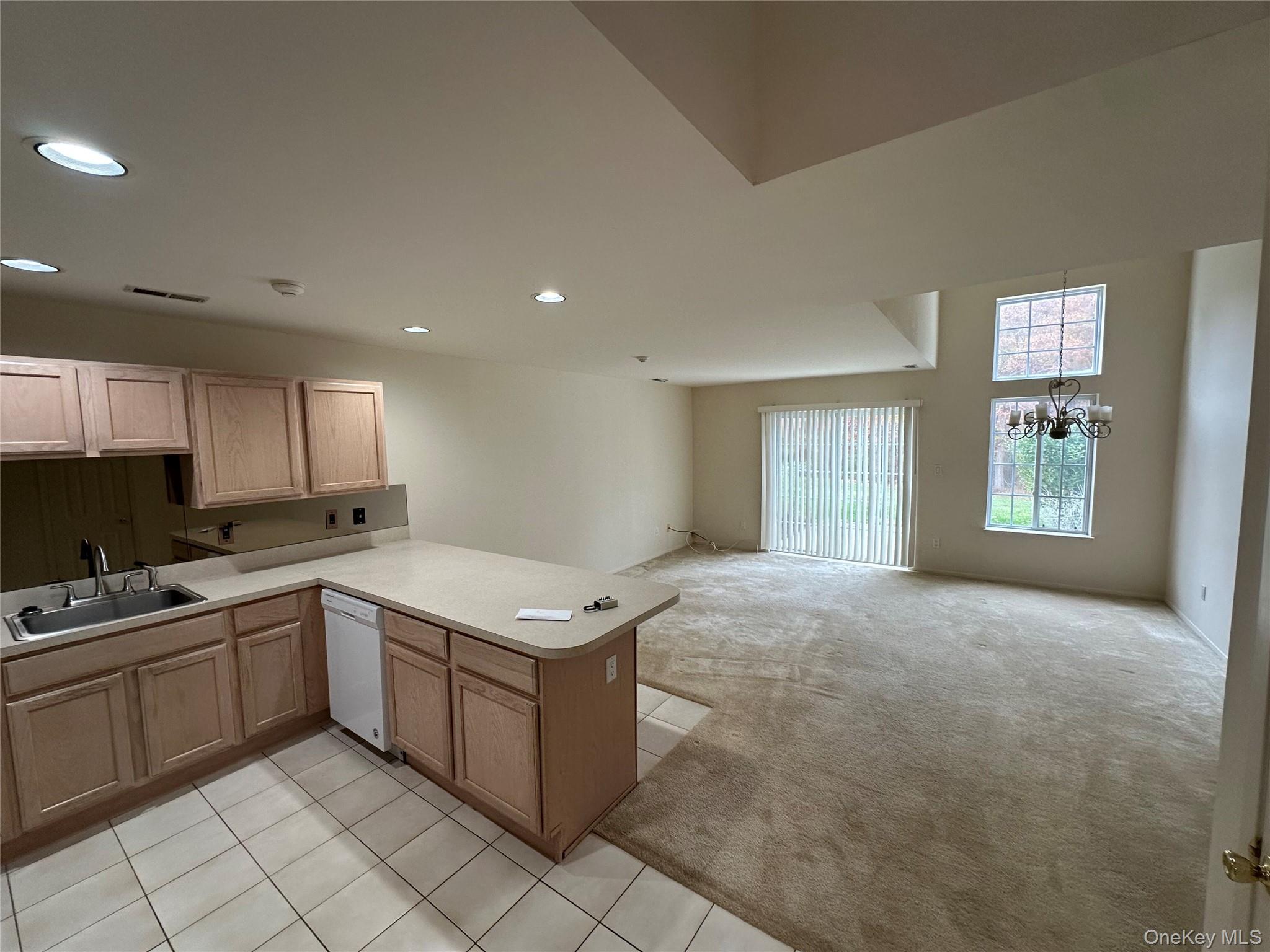 328 Prairie Court Manorville, NY 11949 - Photo 4 of 19 a kitchen with a sink window and cabinets