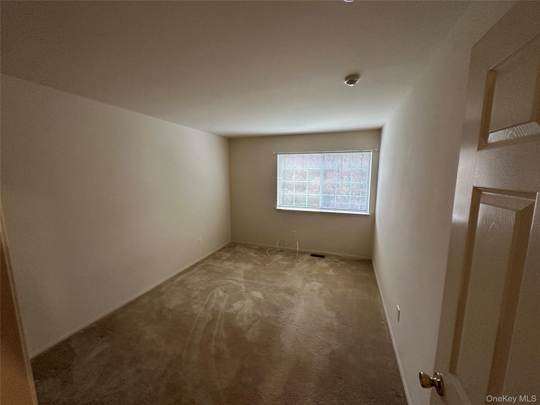 328 Prairie Court Manorville, NY 11949 - Photo 8 of 19 a view of an empty room with a window