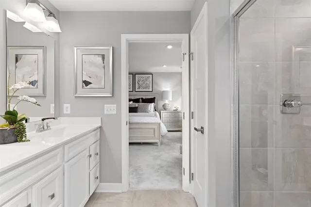 a en suite bathroom with a granite countertop sink mirror and toilet