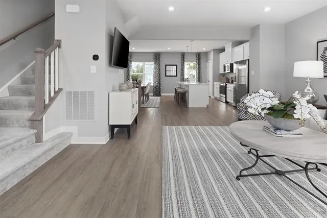 a living room with furniture and wooden floor