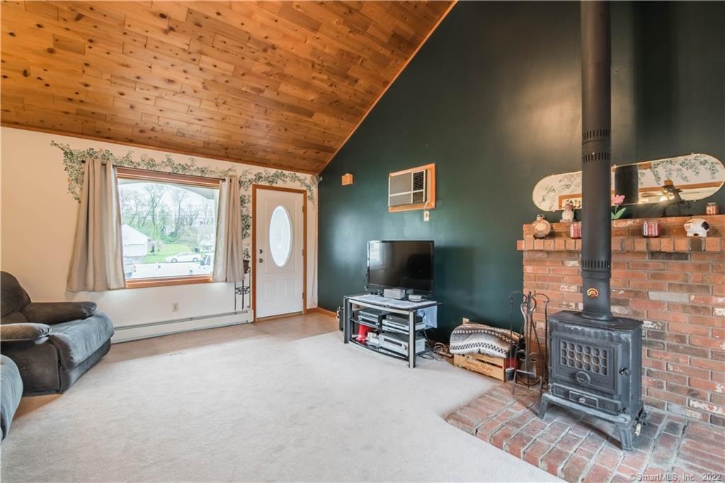 47 Mellor Road Wallingford, CT 06492 - Photo 1 of 1 Walk in to the large great room with wood plank ceiling, and wood stove.