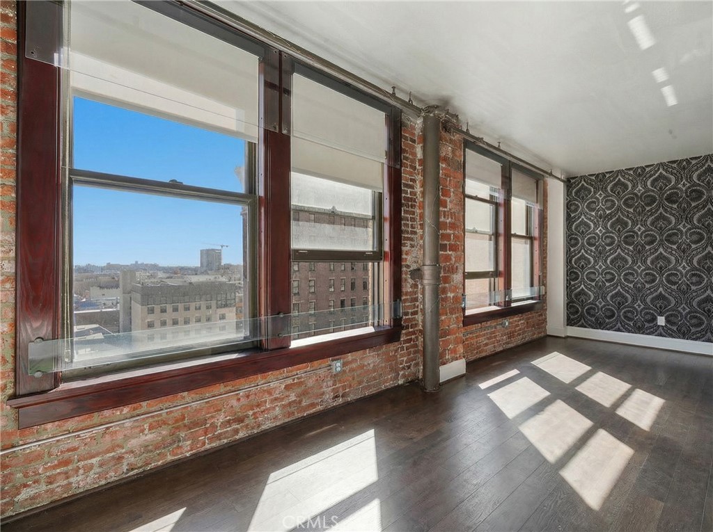 460 South Spring Street, Unit 804 Los Angeles, CA 90013 - Photo 6 of 18 a view of an empty room with wooden floor and a window