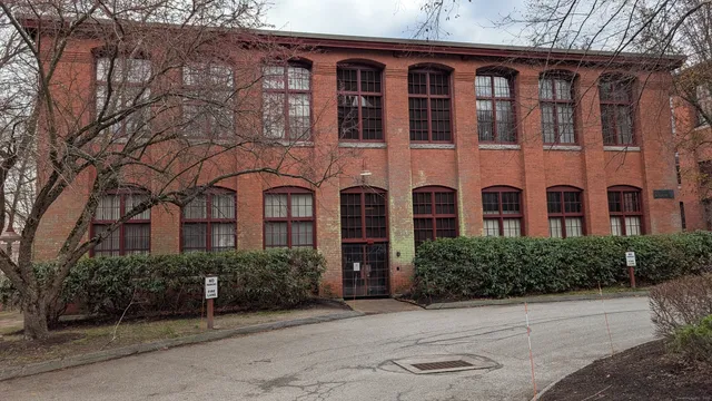front view of a brick house with a yard