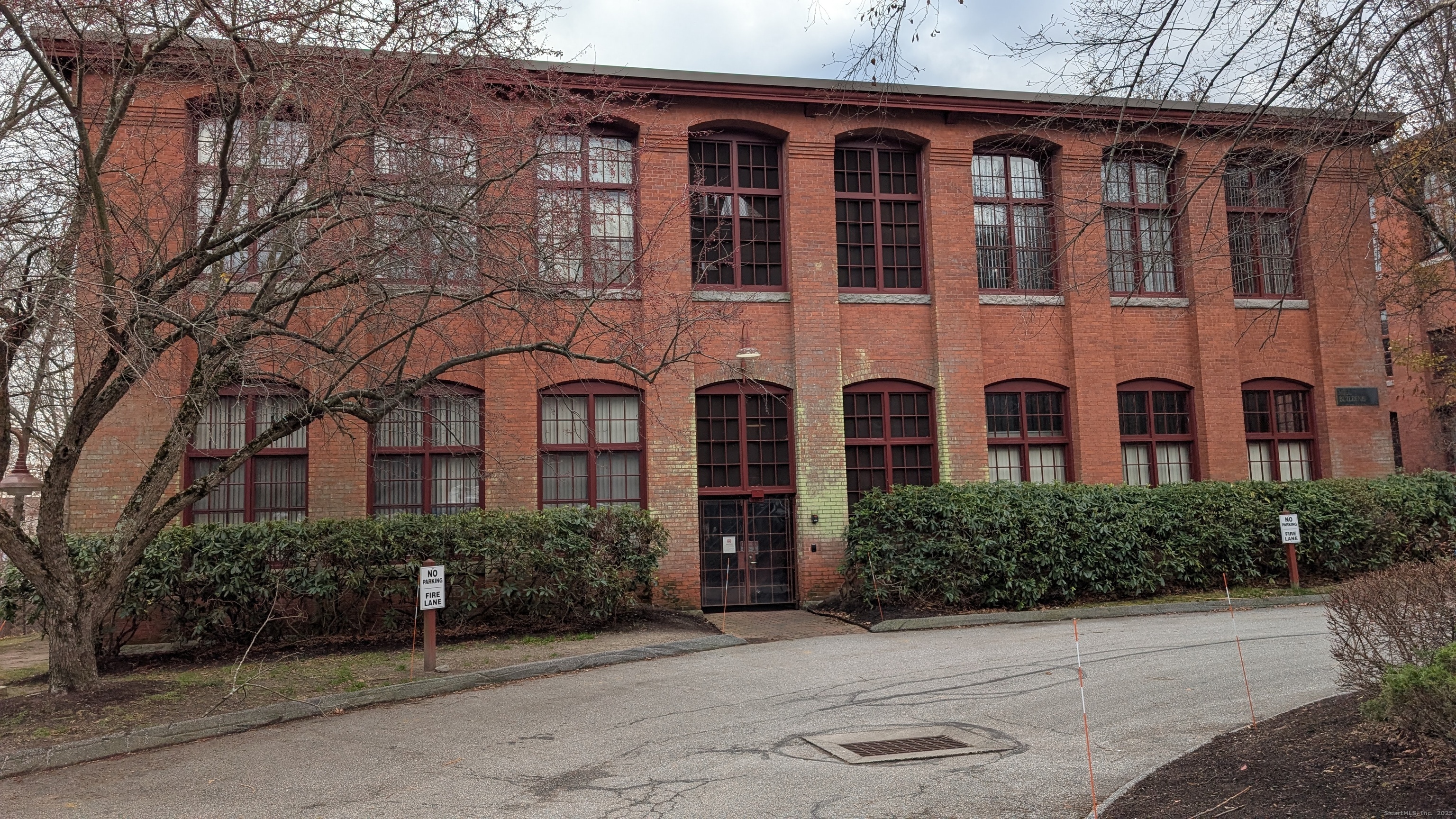 839 Main Street, Unit 61 Torrington, CT 06790 - Photo 1 of 18 front view of a brick house with a yard