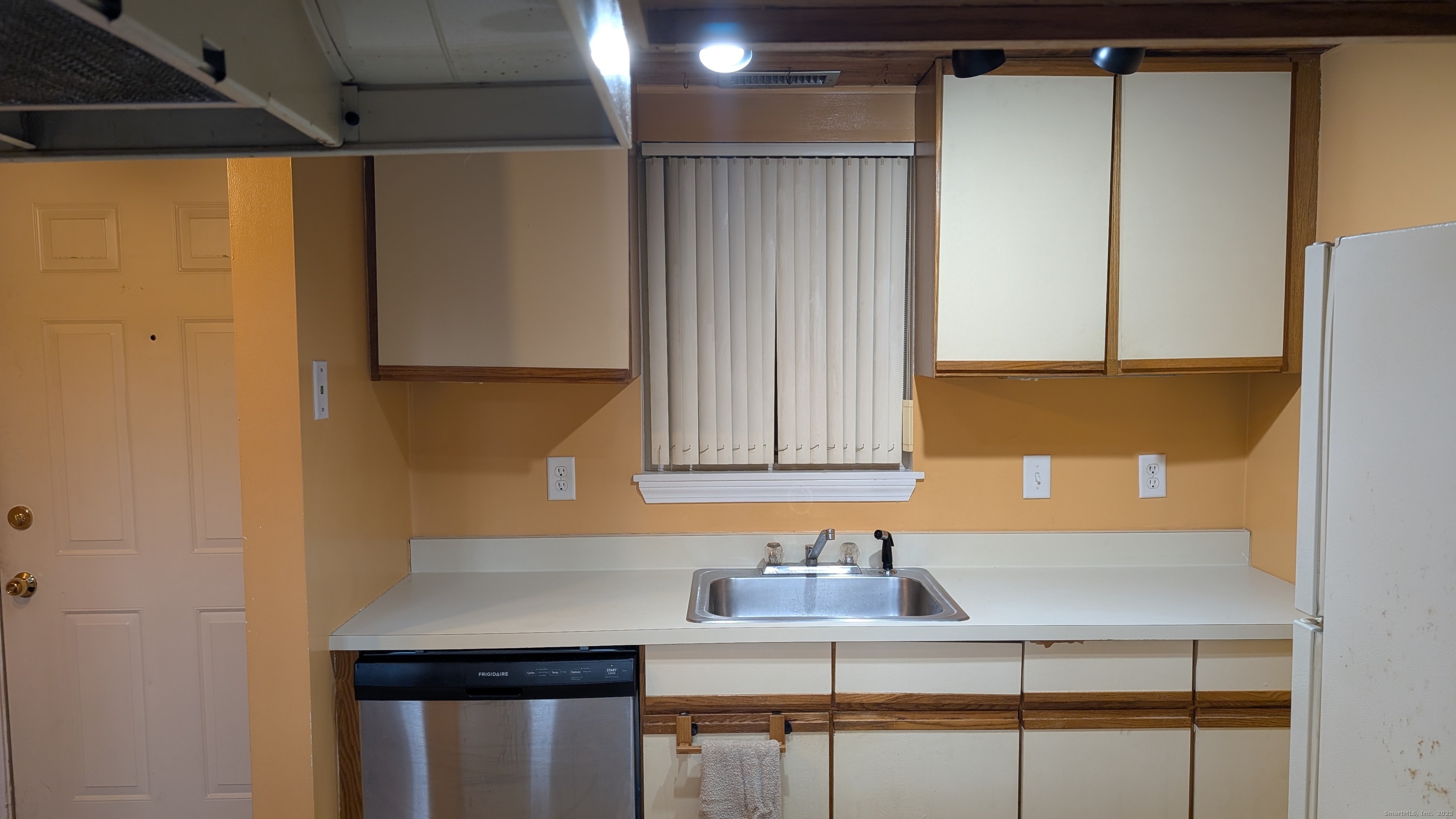 839 Main Street, Unit 61 Torrington, CT 06790 - Photo 8 of 18 a kitchen with a sink a refrigerator and cabinets