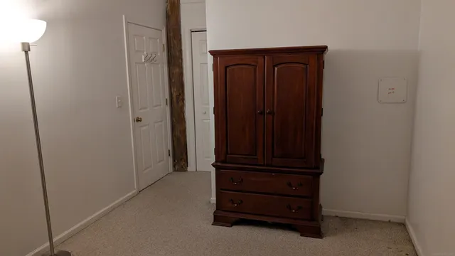 a view of a closet with wooden floor