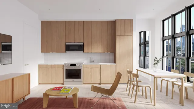 a kitchen with stainless steel appliances granite countertop a stove top oven a sink a dining table and chairs with wooden floor