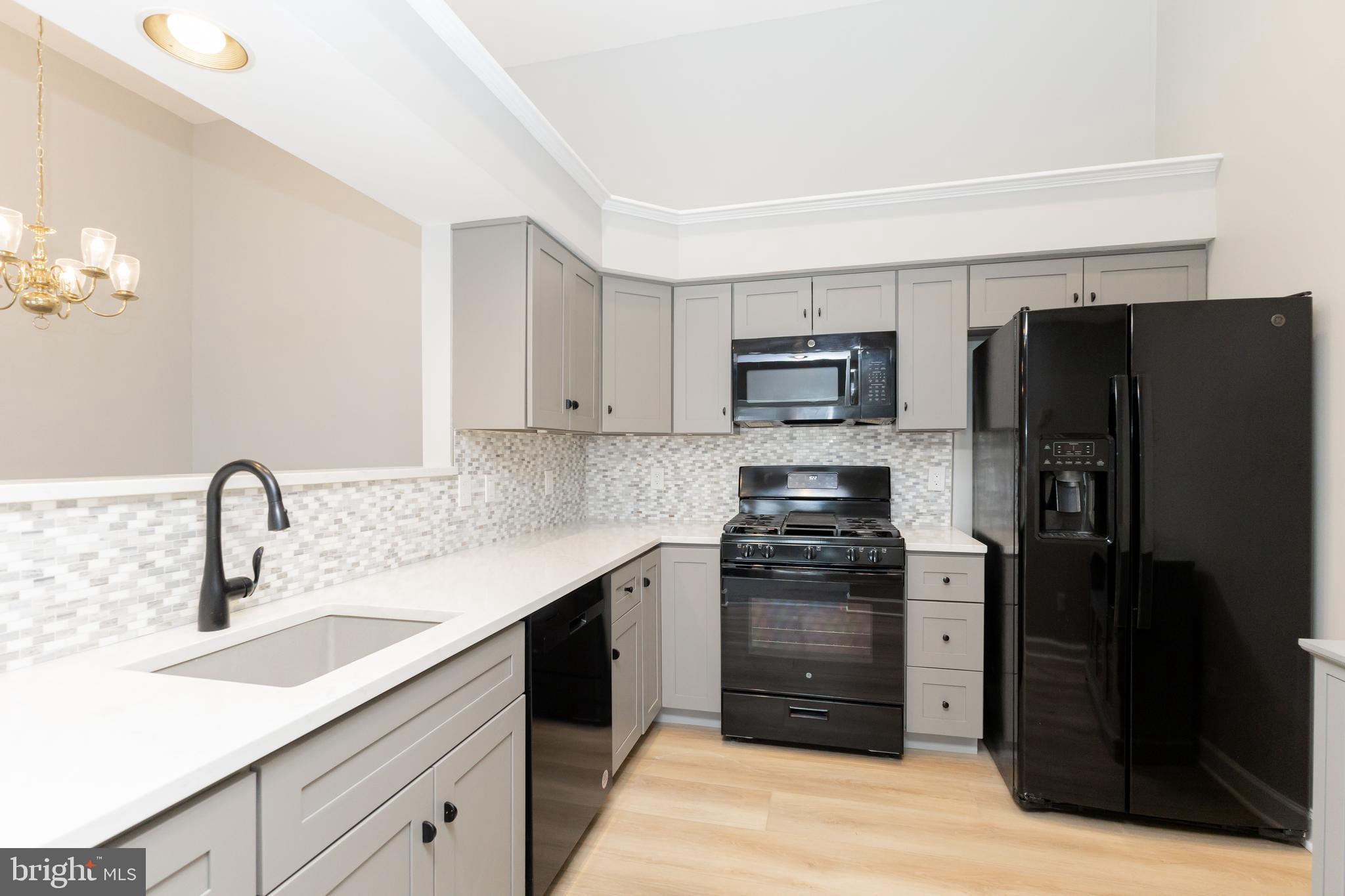 8311 Bluebird Way, Unit K Lorton, VA 22079 - Photo 12 of 25 a kitchen with a refrigerator stove and sink