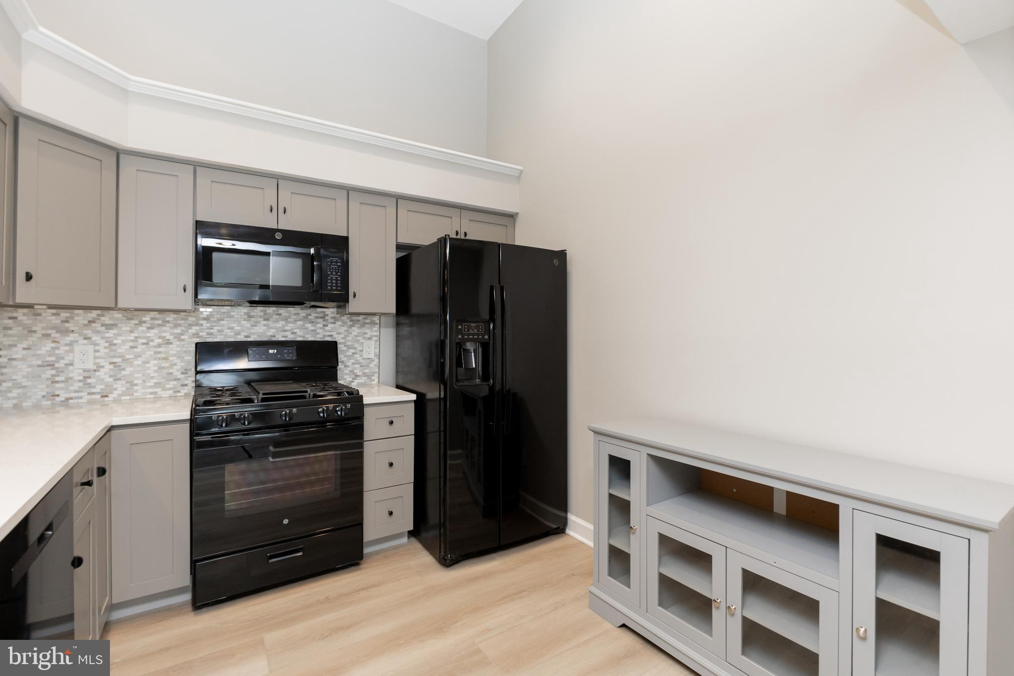 8311 Bluebird Way, Unit K Lorton, VA 22079 - Photo 13 of 25 a kitchen with stainless steel appliances a stove and a refrigerator