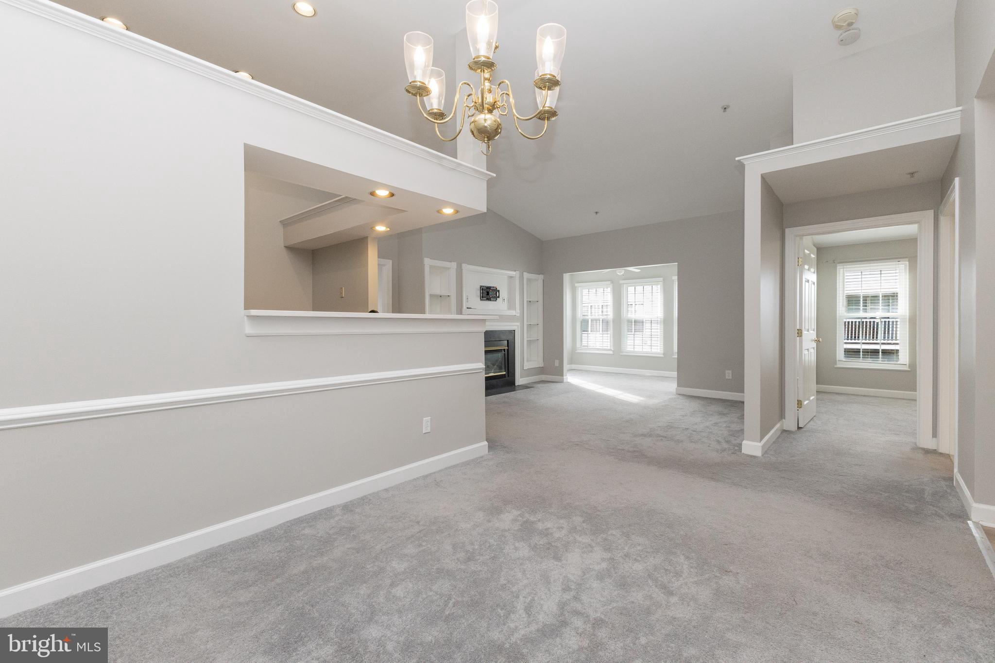 8311 Bluebird Way, Unit K Lorton, VA 22079 - Photo 2 of 25 a view of a big room with chandelier fan and windows