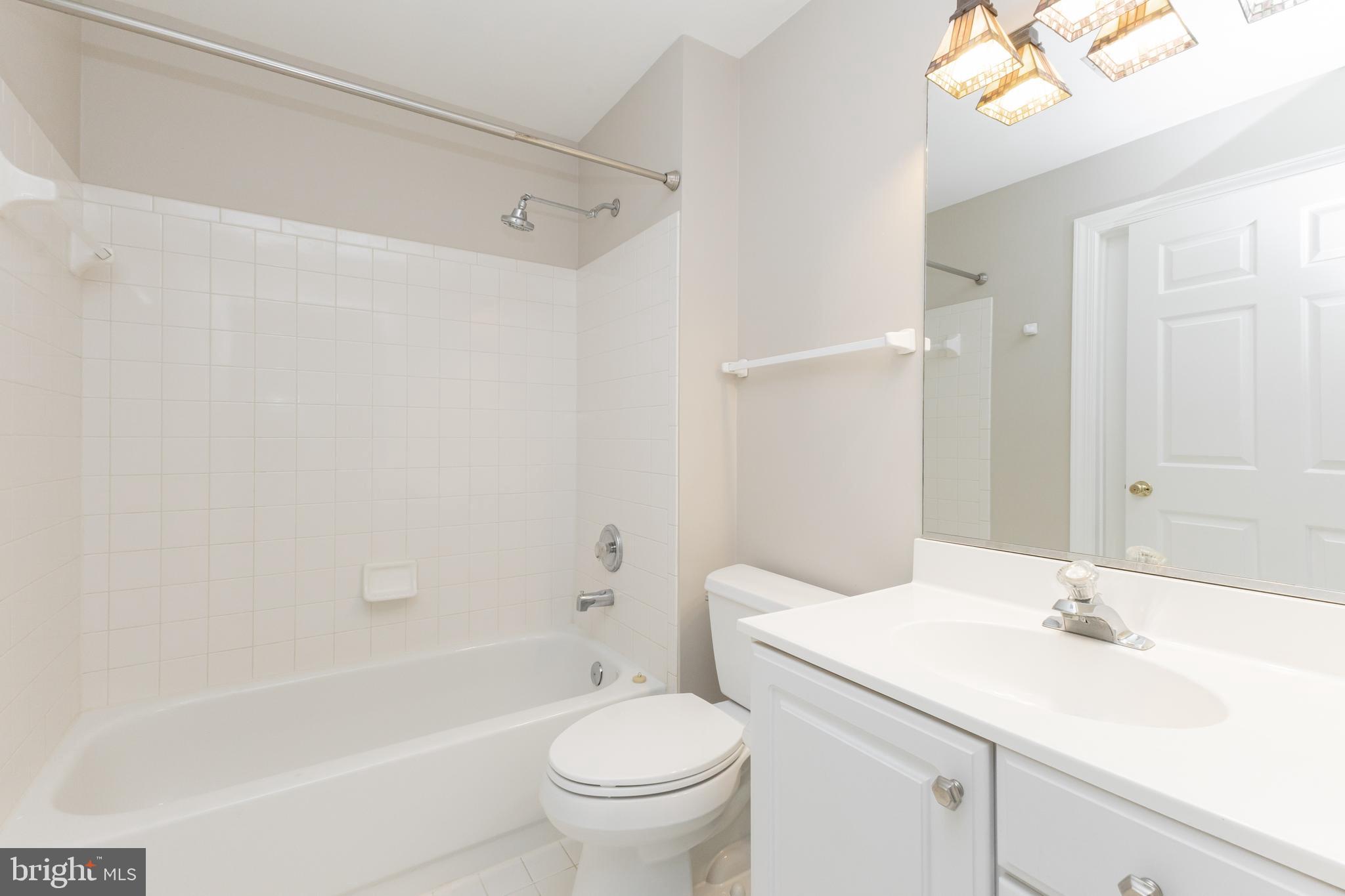 8311 Bluebird Way, Unit K Lorton, VA 22079 - Photo 22 of 25 a bathroom with a sink toilet vanity and shower