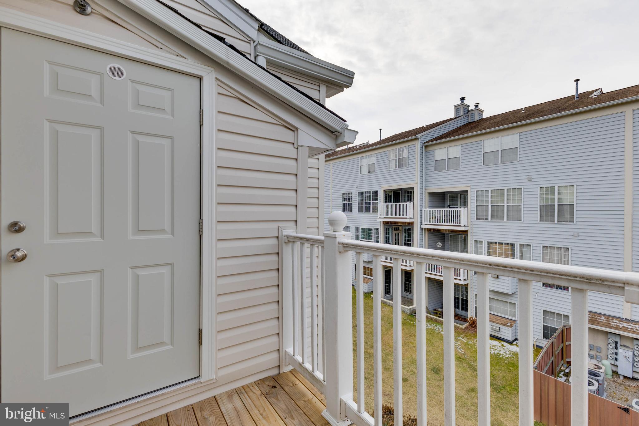 8311 Bluebird Way, Unit K Lorton, VA 22079 - Photo 24 of 25 a front view of a house with a porch