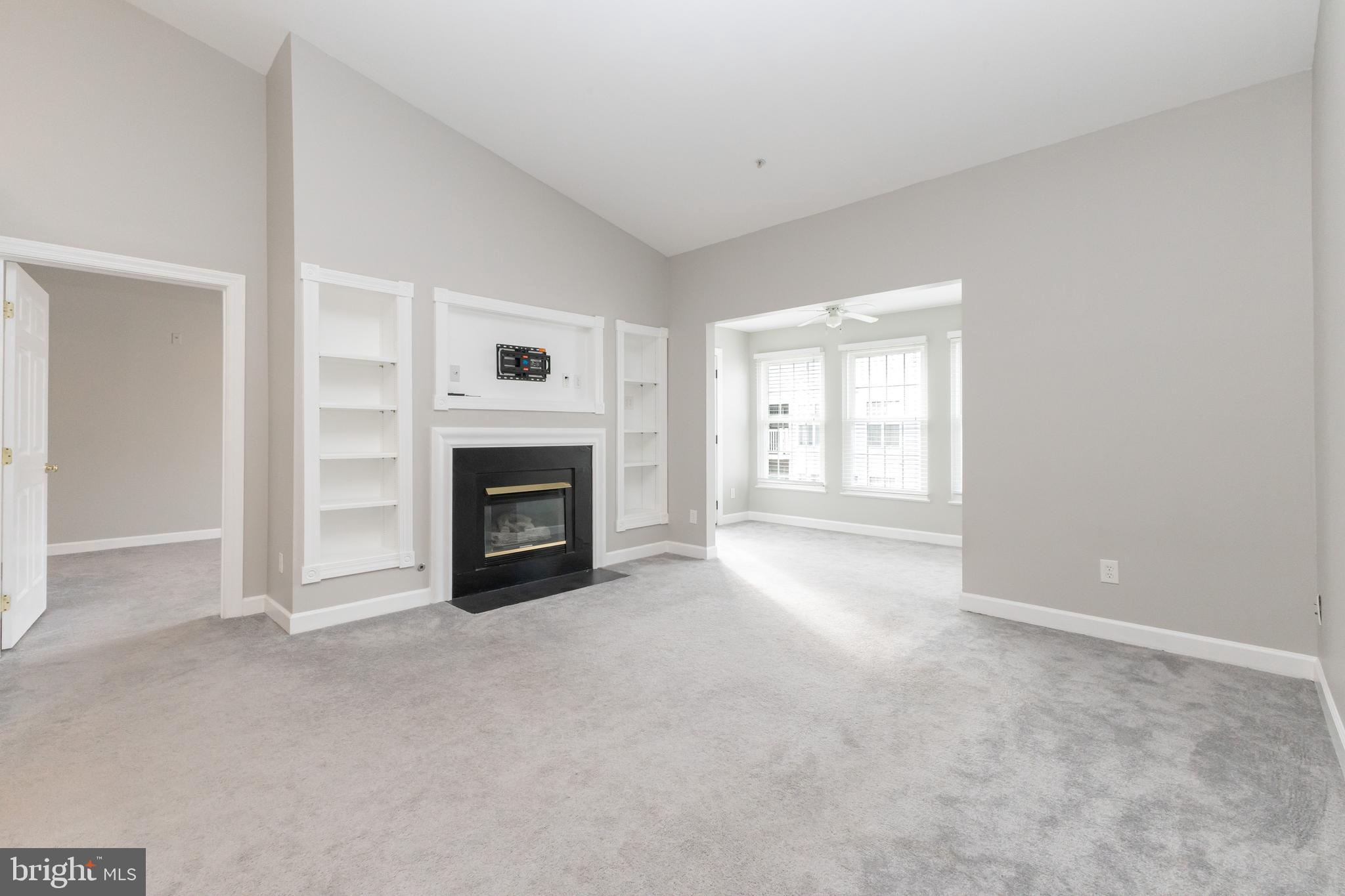 8311 Bluebird Way, Unit K Lorton, VA 22079 - Photo 5 of 25 a view of an empty room with a fireplace and a window