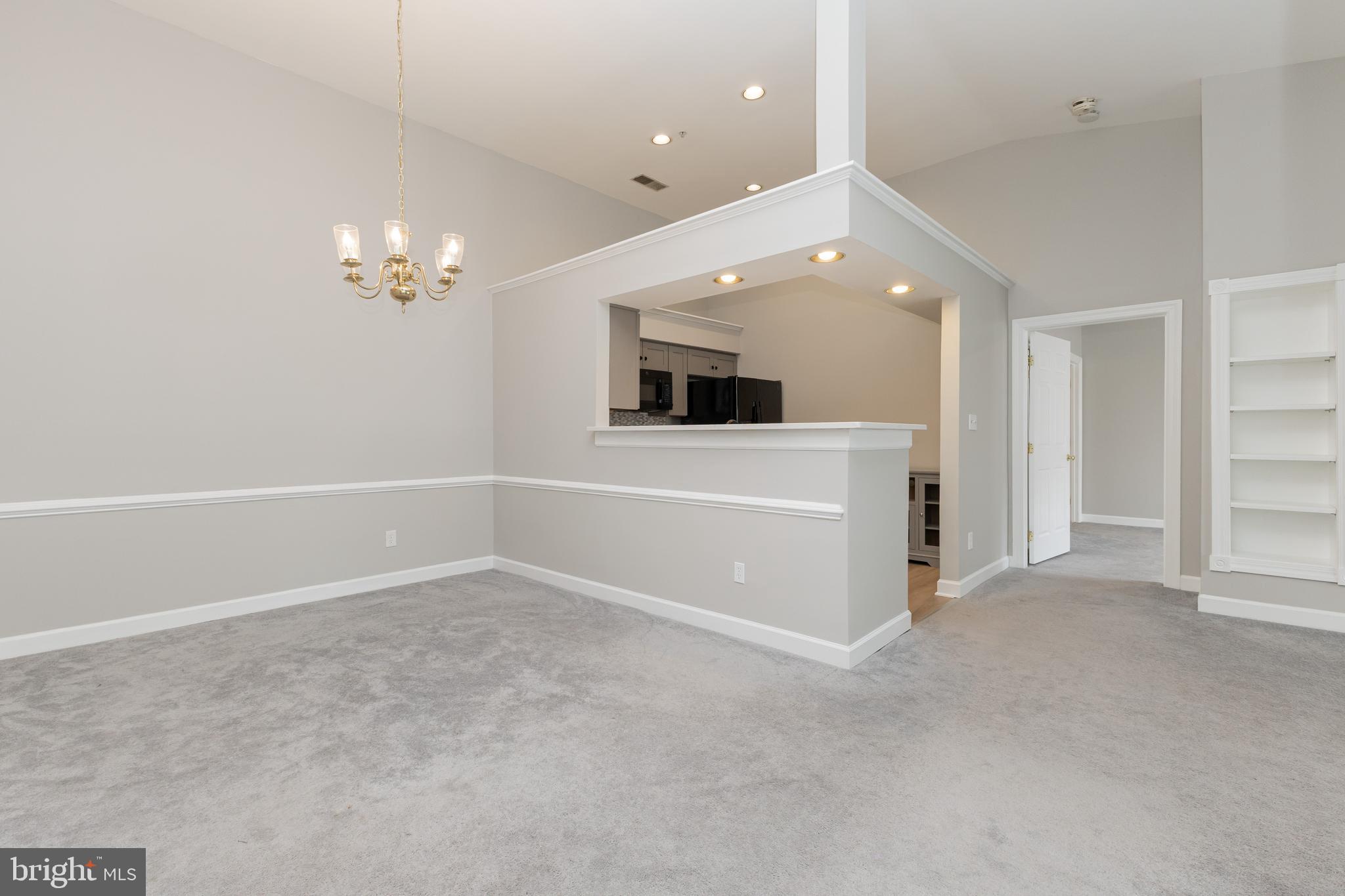 8311 Bluebird Way, Unit K Lorton, VA 22079 - Photo 10 of 25 an empty room with chandelier fan and windows