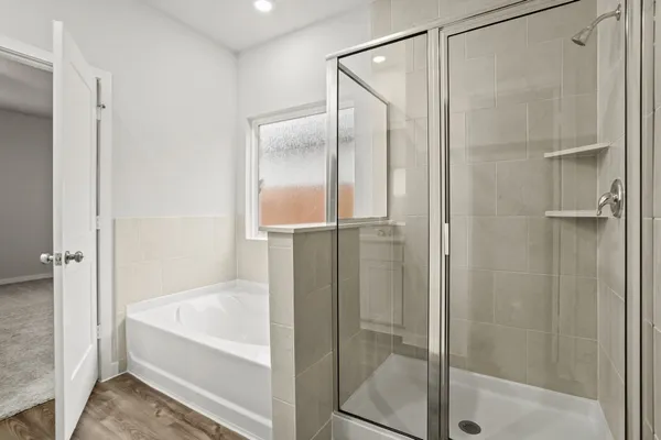 a bathroom with a bathtub and a shower