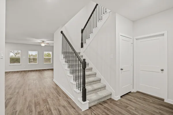 a view of a hallway with wooden floor and entryway